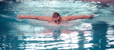 Male swimmer at the swimming pool. Underwater photo. Male swimmer. clipart