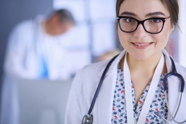 Hastane lobisinde tablet bilgisayar kullanan kadın doktor.