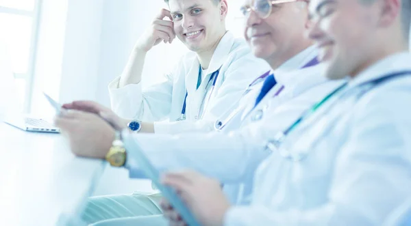 Medical team sitting and discussing at table — Stock Photo, Image