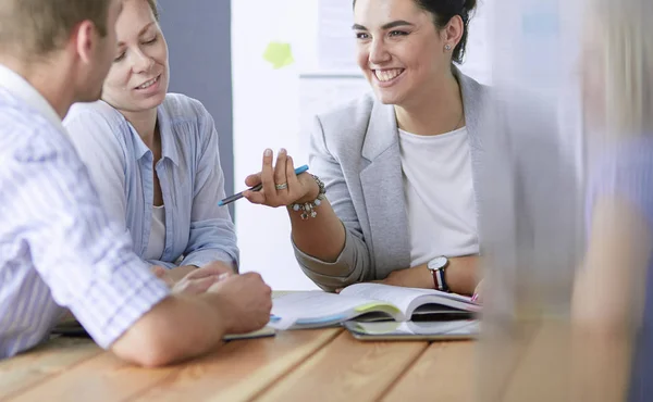 Young people studying with books on desk. Beautiful women and men working together. — Stock Photo, Image