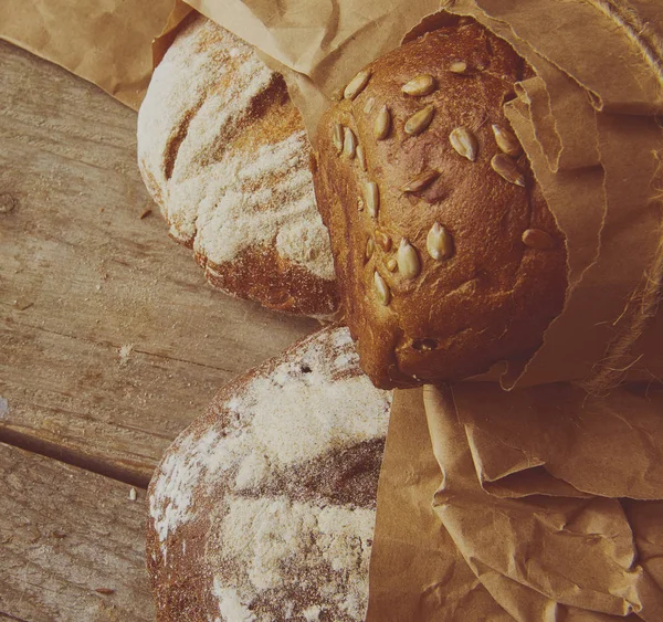 Composition of various breads, on wooden background — Stock Photo, Image