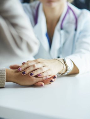 Kadın doktor yaşlılara hastanede el ele tutuşmalarında yardım ediyor