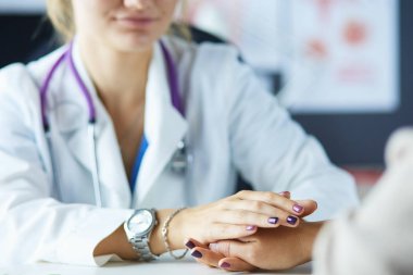 Kadın doktor yaşlılara hastanede el ele tutuşmalarında yardım ediyor