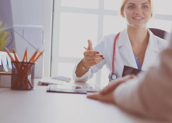 Female doctor holding application form while consulting patient