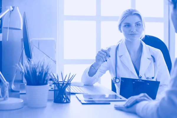 Female doctor holding application form while consulting patient