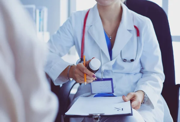 Portrait of doctor explaining bottle of medicine to her patient — Stock Photo, Image