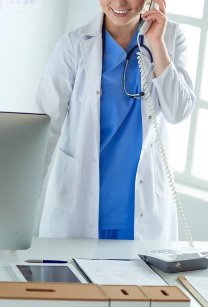 Serious doctor on the phone in her office — Stock Photo, Image