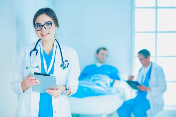 Female doctor using tablet computer in hospital lobby