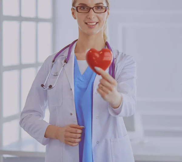 Ženský doktor a stetoskop drží v náručí srdce. Koncepce zdravotnictví a kardiologie v lékařství — Stock fotografie