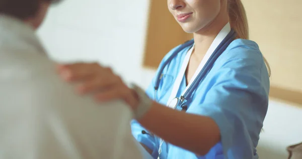 Nurse putting a drip on the arm of her patient — Stock Photo, Image