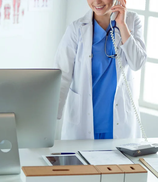 Serious doctor on the phone in her office — Stock Photo, Image