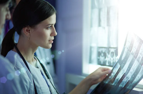 Hospital doctors looking at x-rays in an emergency room Stock Photo
