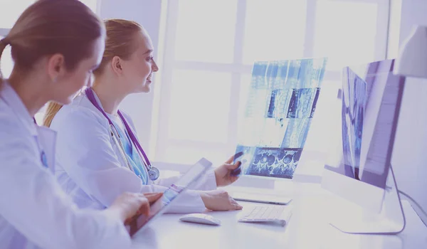 Kobiety lekarze patrząc i omawiając obraz rentgenowski w szpitalu. — Zdjęcie stockowe