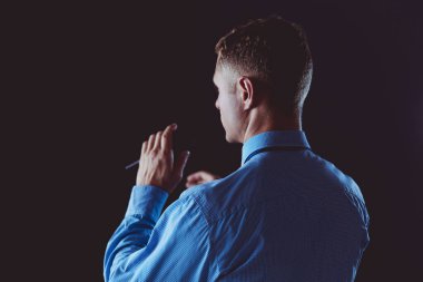 İş adamı konuşması, konferans salonunda mikrofonla konuşmak.