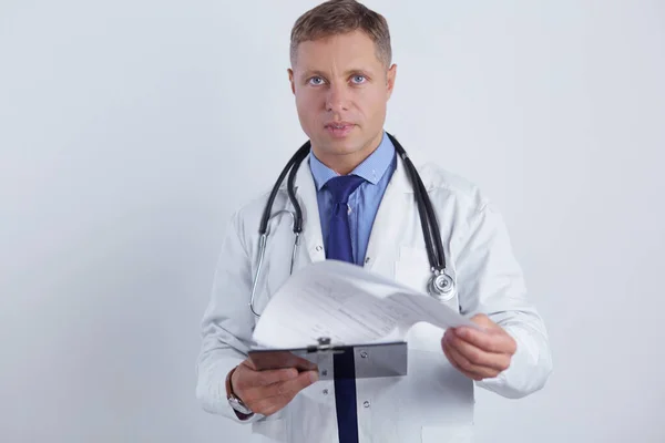 Male doctor standing with folder, isolated on white background — Stock Photo, Image