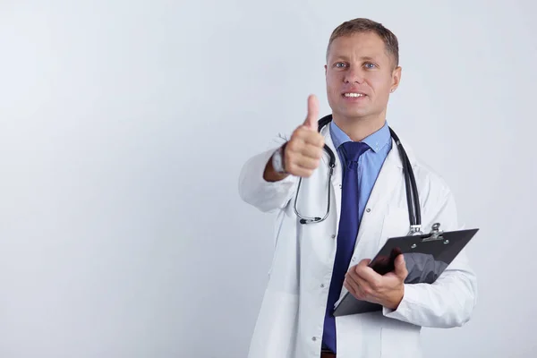 Портрет красивого врача в белом халате, держащего папку, показывающую знак ОК — стоковое фото