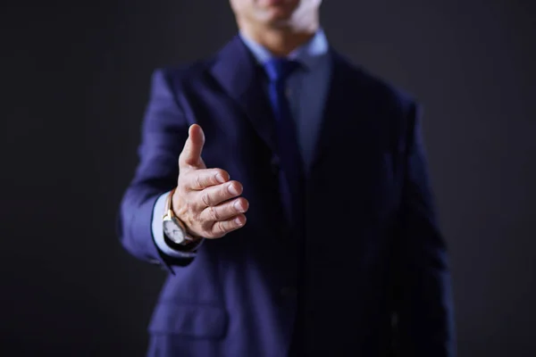 Portrait of a businessman standing with a microphone and looking ahead, speak at the conference — Stock Photo, Image