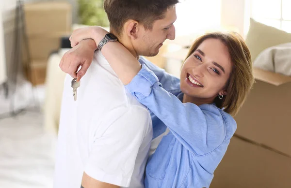 Happy couple hugging in their new house — Stock Photo, Image