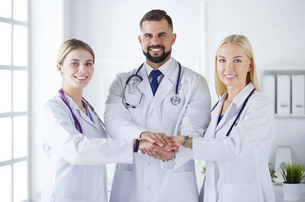 Doctors and nurses in a medical team stacking hands — Stock Photo, Image