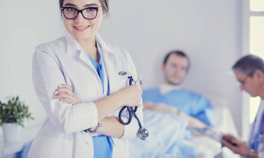 Kadın doktor hastanede steteskopla dikiliyor.
