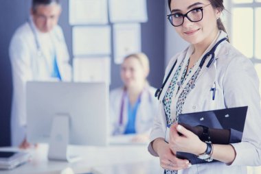 Kadın doktor hastanede steteskopla dikiliyor.