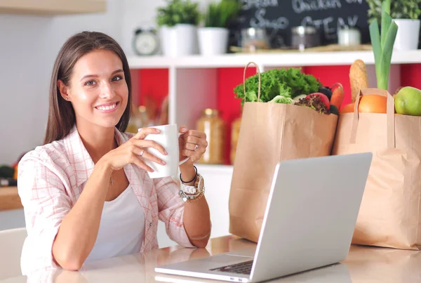 Lächelnde Frau beim Online-Shopping mit Tablet und Kreditkarte in der Küche. Lächelnde Frau — Stockfoto