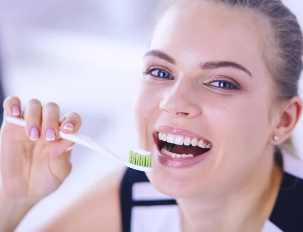 Junges hübsches Mädchen pflegt Mundhygiene mit Zahnbürste. — Stockfoto