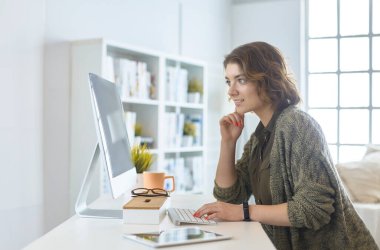 Evde tablet bilgisayar kullanan genç bir kadın ya da öğrenci