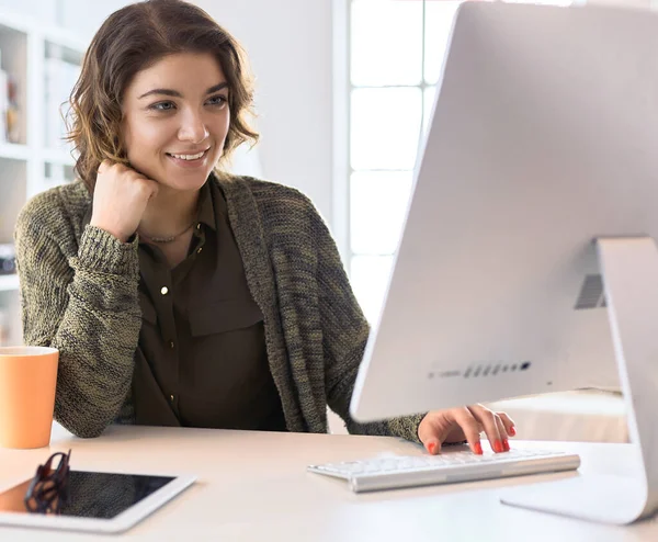 Krásná usměvavá studentka pomocí online vzdělávací služby — Stock fotografie