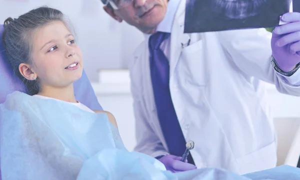 Niña sentada en el consultorio de dentistas — Foto de Stock