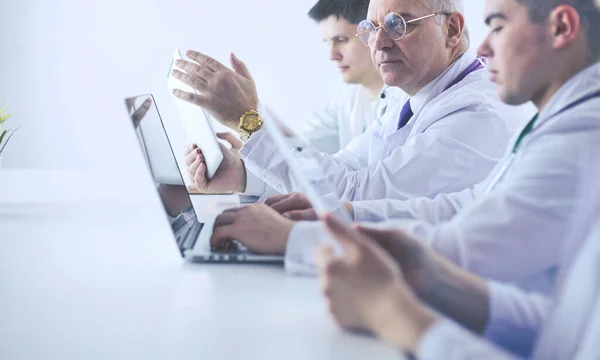 Medical team sitting and discussing at table — Stock Photo, Image