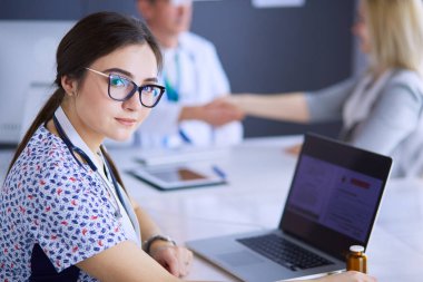 Doktor ve hasta masada otururken bir şey tartışıyorlar. İlaç ve sağlık hizmetleri kavramı