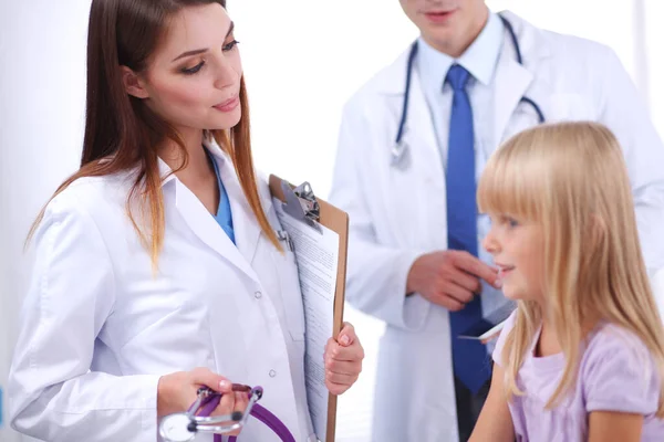 Female doctor examining child with stethoscope at surgery — Stock Photo, Image