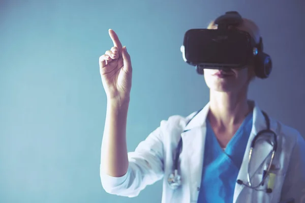 Female doctor wearing virtual reality glasses isolated on white background.