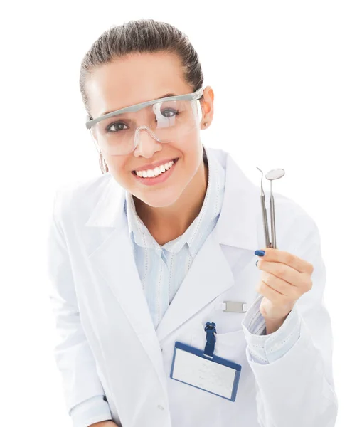 Beautiful female dentist doctor holding and showing toothbrush isolated on a white background — Fotografie, imagine de stoc