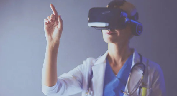 Female doctor wearing virtual reality glasses isolated on white background.