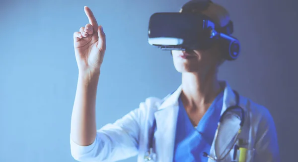 Female doctor wearing virtual reality glasses isolated on white background.