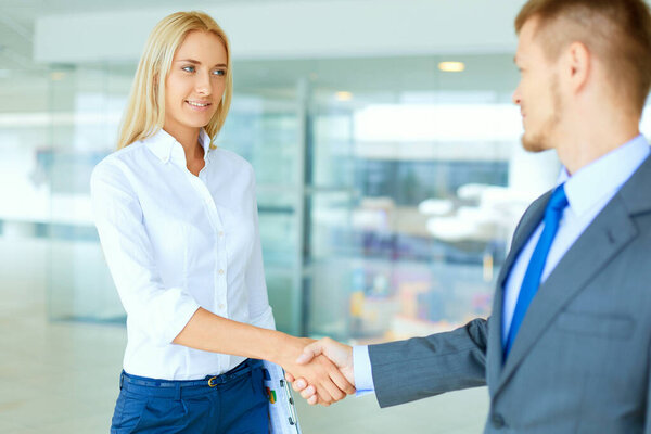 Two successful business people shaking hands with each other