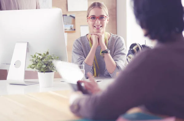 Female dressmaker is communicating with the potential client about custom-made dress in the sewing workshop — Stock Photo, Image