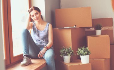 Karton kutularla dolu yeni bir evde bir kadın. Evdeki kadın..