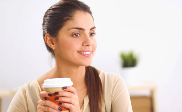 Beautiful businesswoman enjoying coffee in bright office — Stock Photo, Image
