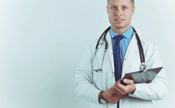 Male doctor standing with folder, isolated on white background — Stock Photo, Image