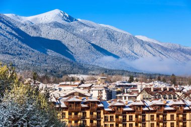 Houses and snow mountains in Bansko, Bulgaria clipart
