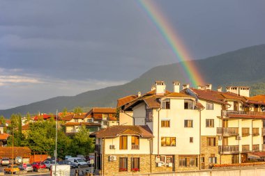 Bansko, Bulgaria - August 2, 2025: Town summer panorama of bulgarian all season resort with and rainbow