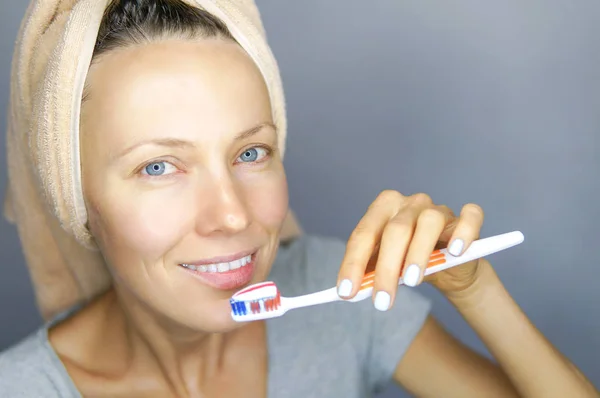 Woman brushing cleaning teeth.  Morning routine: girl with toothbrush. Oral hygiene