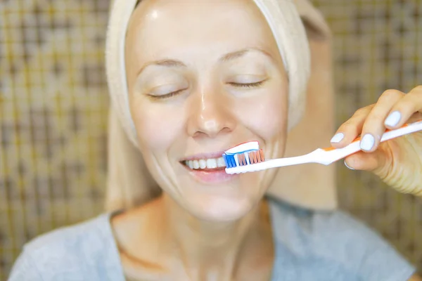 Woman brushing cleaning teeth.  Morning routine: girl with toothbrush. Oral hygiene