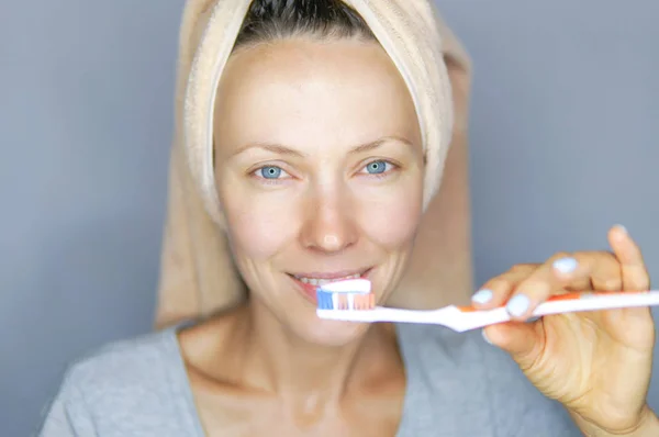 Woman brushing cleaning teeth.  Morning routine: girl with toothbrush. Oral hygiene