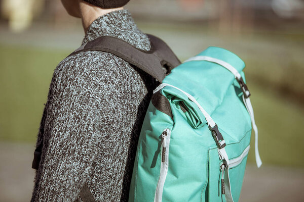 Hipster young girl with backpack enjoying city warm days, detail