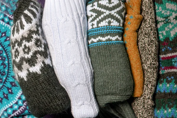 Heap of knitted sweaters background. hellow autumn or winter concept