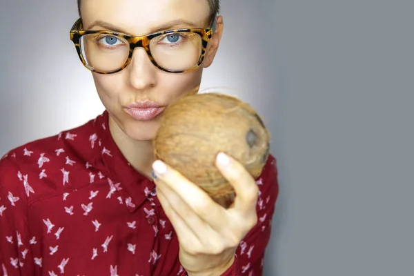 Funny woman like man holding coconut and sending kisses looking playful